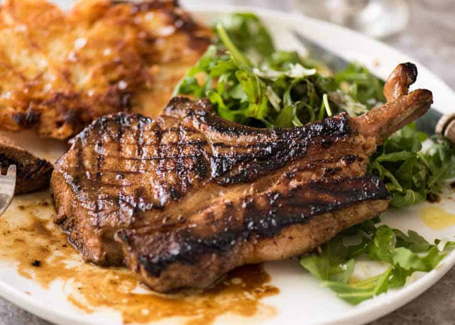 Grilled chops on a plate, made using a great Pork Chop Marinade