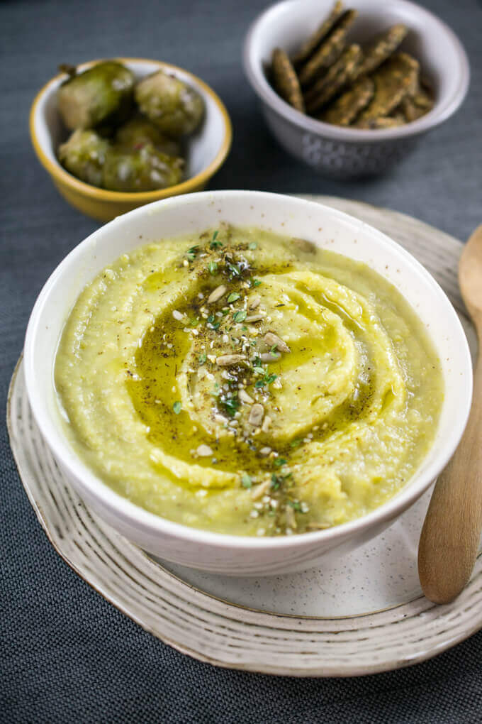 A bowl of vegan Lebanese green split pea soup, with a drizzle of olive oil on top and a generous sprinkling of za